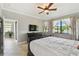 Inviting bedroom with view to lanai, a large bed, dresser, and a scenic view through large windows at 925 Grand Canal Dr, Poinciana, FL 34759