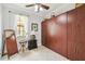 Bedroom featuring Murphy bed, tile flooring, a window, and neutral color palette at 925 Grand Canal Dr, Poinciana, FL 34759