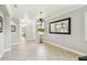 A neutral dining room features tile floors, a chandelier, and a large mirror at 925 Grand Canal Dr, Poinciana, FL 34759