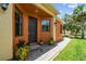 Inviting front entrance with stone pathway, stylish decor, and lush plants at 925 Grand Canal Dr, Poinciana, FL 34759