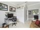 Comfortable home office with neutral paint, tiled floor, a desk, and a view into the living room at 925 Grand Canal Dr, Poinciana, FL 34759