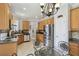 Kitchen features stainless appliances, wood cabinets, and a breakfast nook at 925 Grand Canal Dr, Poinciana, FL 34759