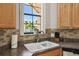 Charming kitchen featuring a double sink, modern faucet, and views of a serene lake and palm trees at 925 Grand Canal Dr, Poinciana, FL 34759