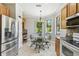 Bright kitchen nook featuring stainless steel appliances and ample natural light at 925 Grand Canal Dr, Poinciana, FL 34759