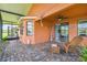 Charming covered lanai with brick pavers, comfortable seating, and access to the outdoors at 925 Grand Canal Dr, Poinciana, FL 34759
