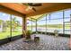 Relaxing screened lanai with brick pavers and a beautiful view of the lake at 925 Grand Canal Dr, Poinciana, FL 34759
