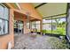 Comfortable lanai with brick pavers, a wicker chair, and views of the yard and neighborhood at 925 Grand Canal Dr, Poinciana, FL 34759
