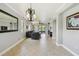 Spacious living room with neutral tones, chandelier, tile floors, and views of the lake at 925 Grand Canal Dr, Poinciana, FL 34759