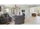 Comfortable living room with neutral colors, ceiling fan, and access to the patio and other rooms at 925 Grand Canal Dr, Poinciana, FL 34759