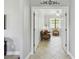 Hallway leading to a living room furnished with sofa and upholstered armchairs at 925 Grand Canal Dr, Poinciana, FL 34759