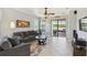 Cozy living room with views of a lake and patio, featuring neutral tones and ample seating at 925 Grand Canal Dr, Poinciana, FL 34759