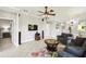 Open-concept living room with tile floors, neutral walls, and a stylish seating arrangement at 925 Grand Canal Dr, Poinciana, FL 34759
