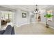 Bright and spacious living room with neutral colors, tile flooring, and view into other rooms at 925 Grand Canal Dr, Poinciana, FL 34759