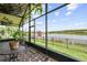 Screened-in patio with brick floor features a lovely view of the lake at 925 Grand Canal Dr, Poinciana, FL 34759