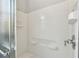 Bright bathroom shower featuring white tiled walls and a sleek chrome faucet at 925 Grand Canal Dr, Poinciana, FL 34759