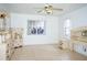 Bright bedroom with tiled floors, a ceiling fan, and matching furniture sets at 926 Chula Ct, Lady Lake, FL 32159