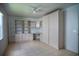 Neutral bedroom with tile flooring, custom built-in shelving, closet, and workspace at 926 Chula Ct, Lady Lake, FL 32159