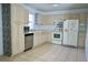 Functional kitchen features tiled floors and white appliances at 926 Chula Ct, Lady Lake, FL 32159