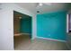 Bright room with tile flooring, light-colored walls, and teal accent wall with decorative lettering at 926 Chula Ct, Lady Lake, FL 32159