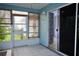 Enclosed sunroom with tile flooring, wood blinds, and access to the backyard through a sliding glass door at 926 Chula Ct, Lady Lake, FL 32159