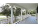 Long balcony features white railing and columns with a view of a pond at 934 Westpark Dr, Celebration, FL 34747