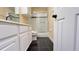 This bathroom has a modern vanity, a toilet, and a shower-tub combo with black tile accents at 934 Westpark Dr, Celebration, FL 34747