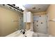 Bathroom features double sink vanity, decorative fish tile and shower/tub with fish tile border at 934 Westpark Dr, Celebration, FL 34747