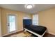 Cozy bedroom has a comfortable bed, ample natural light, and private access to the balcony through the door at 934 Westpark Dr, Celebration, FL 34747