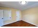 The bedroom has hardwood floors and neutral walls with a closet for storage at 934 Westpark Dr, Celebration, FL 34747