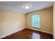 Bedroom features hardwood floors, a window with natural light, and neutral-colored walls at 934 Westpark Dr, Celebration, FL 34747