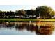Scenic community view with a lake surrounded by lush greenery and an elegant home in the background at 934 Westpark Dr, Celebration, FL 34747