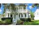 Charming two-story home with a inviting front porch, white columns, manicured landscaping, and well-maintained lawn at 934 Westpark Dr, Celebration, FL 34747