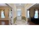 Inviting foyer with tiled floors and decorative trim, leading to rooms with hardwood flooring and elegant window treatments at 934 Westpark Dr, Celebration, FL 34747