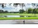 Picturesque golf course view with lush green fairways and a tranquil pond under a partly cloudy sky at 934 Westpark Dr, Celebration, FL 34747
