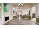 Open-concept living room with tile floors, fireplace, and staircase to the second level at 934 Westpark Dr, Celebration, FL 34747