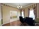 Spacious office area featuring a dark wood desk, two chairs, and striped wallpaper at 934 Westpark Dr, Celebration, FL 34747