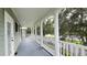 Spacious porch featuring white pillars and railing overlooking a lake view at 934 Westpark Dr, Celebration, FL 34747