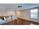 Upstairs hallway features hardwood floors and views of the downstairs foyer at 934 Westpark Dr, Celebration, FL 34747