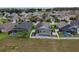 Aerial view showing multiple homes with solar panels, pools, and backyard at 973 Corvina Dr, Davenport, FL 33897