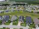Aerial view showcasing numerous homes with solar panels, and pools at 973 Corvina Dr, Davenport, FL 33897