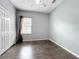 A bright bedroom features hardwood floors, neutral gray walls, and a closet at 973 Corvina Dr, Davenport, FL 33897