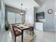 Bright dining area with set table, tile floors, large window and a decorative pendant light fixture at 973 Corvina Dr, Davenport, FL 33897
