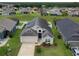 Charming single-story home with a well-manicured lawn, inviting entrance, solar panels, and two-car garage at 973 Corvina Dr, Davenport, FL 33897