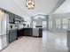 Open-concept kitchen with gray cabinets, stainless steel appliances, and an island with seating at 973 Corvina Dr, Davenport, FL 33897