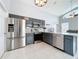 Well-appointed kitchen featuring gray cabinetry, stainless steel appliances, and granite countertops at 973 Corvina Dr, Davenport, FL 33897