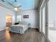 Well-lit main bedroom features wood look floors and outdoor access through glass doors at 973 Corvina Dr, Davenport, FL 33897