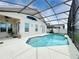 Screened-in pool with spacious deck and tranquil water. Perfect for relaxation at 973 Corvina Dr, Davenport, FL 33897