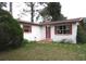 Charming single-story home featuring a well-maintained lawn and unique window details at 12019 Ne 212Th Street Rd, Fort Mc Coy, FL 32134