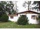 Cozy home exterior with well-established trees and bushes in the front yard at 12019 Ne 212Th Street Rd, Fort Mc Coy, FL 32134