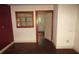 Living room with wood floors and walls, a wooden window trim, and an open doorway at 12019 Ne 212Th Street Rd, Fort Mc Coy, FL 32134